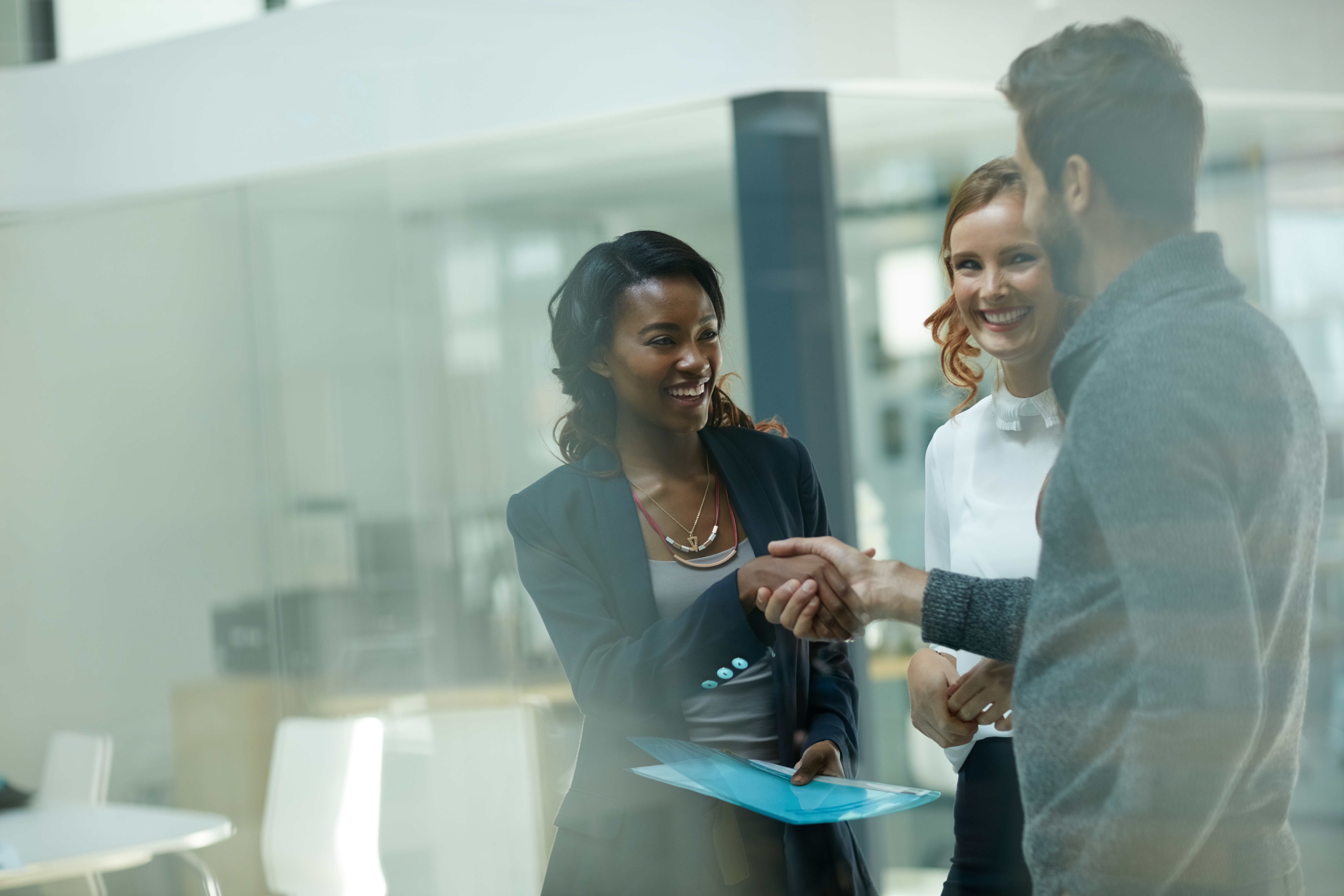 A woman being welcomed by her colleagues as she starts a new career.