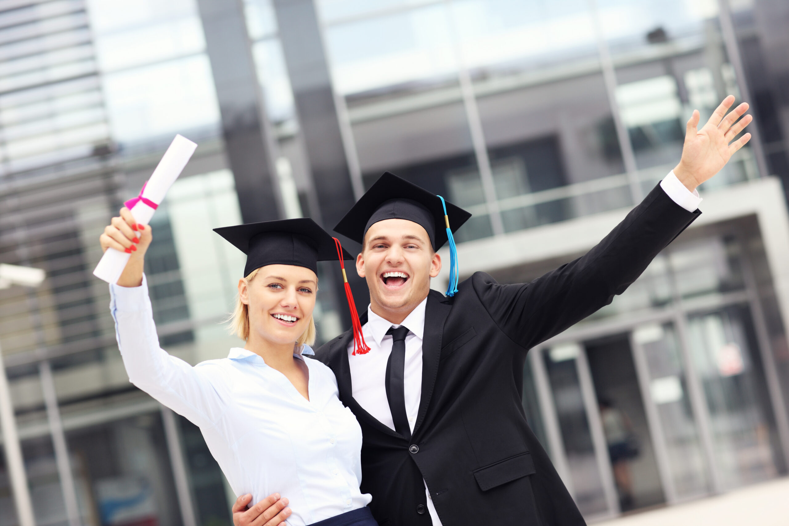 Two grads celebrating success and job opportunities for new graduates.